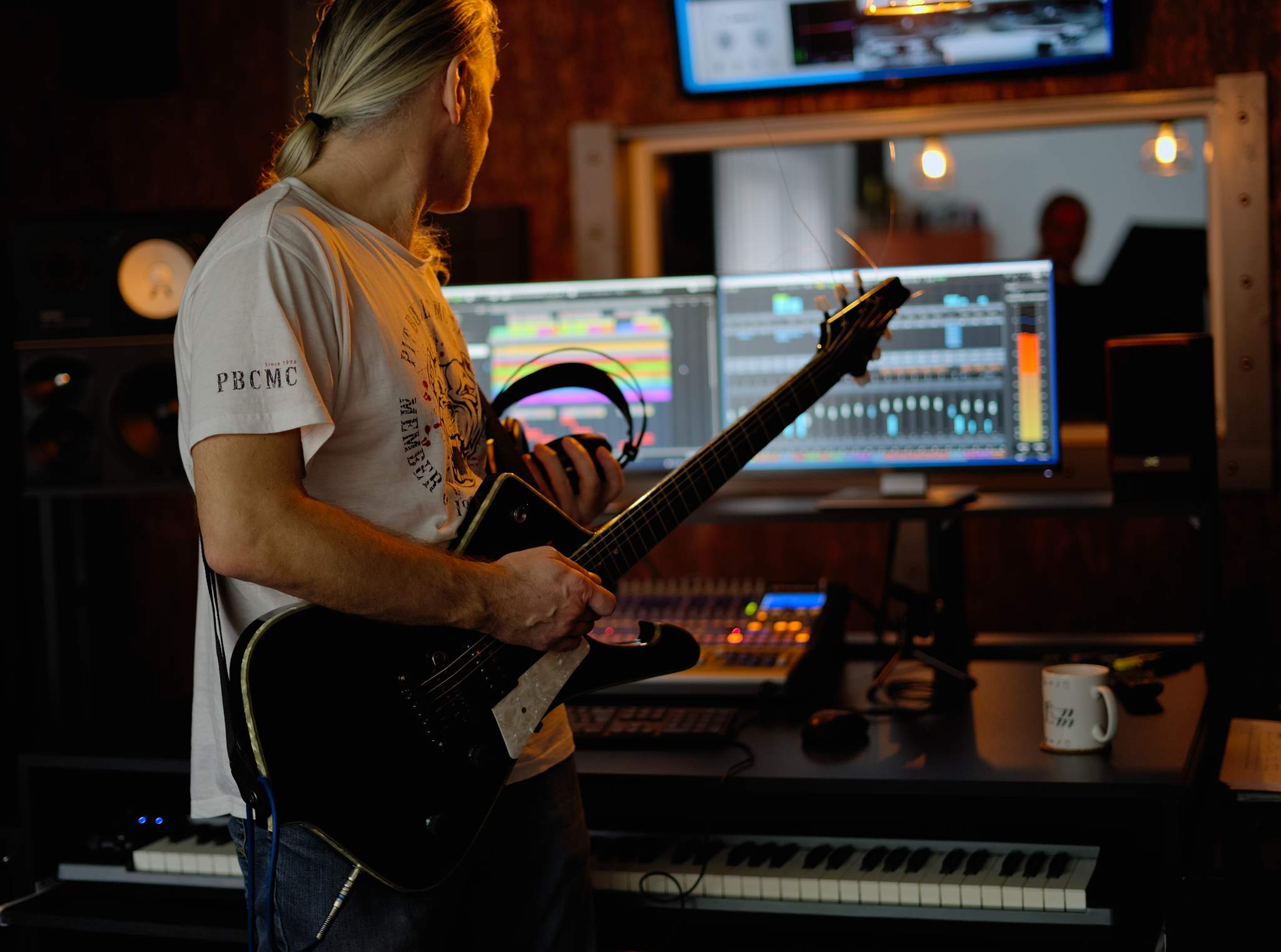 Michal in studio with a bass guitar